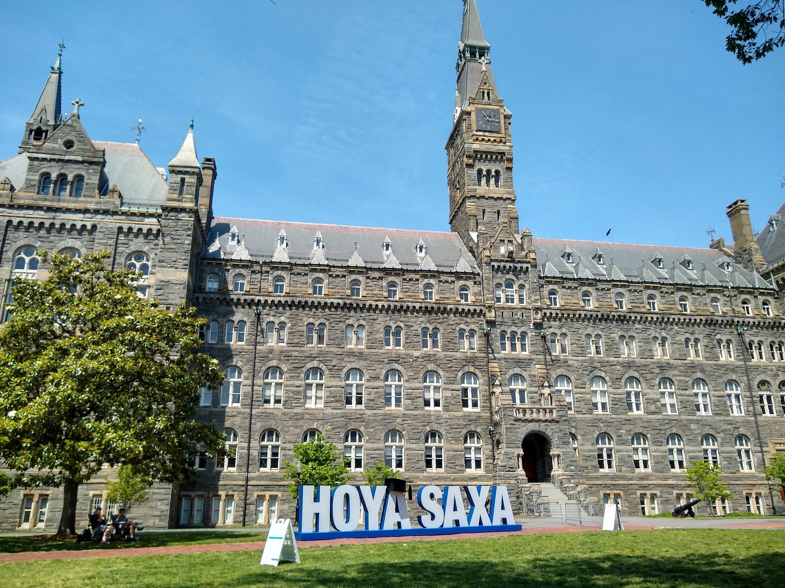 Healy Hall with a HOYA SAXA sign on the front lawn
