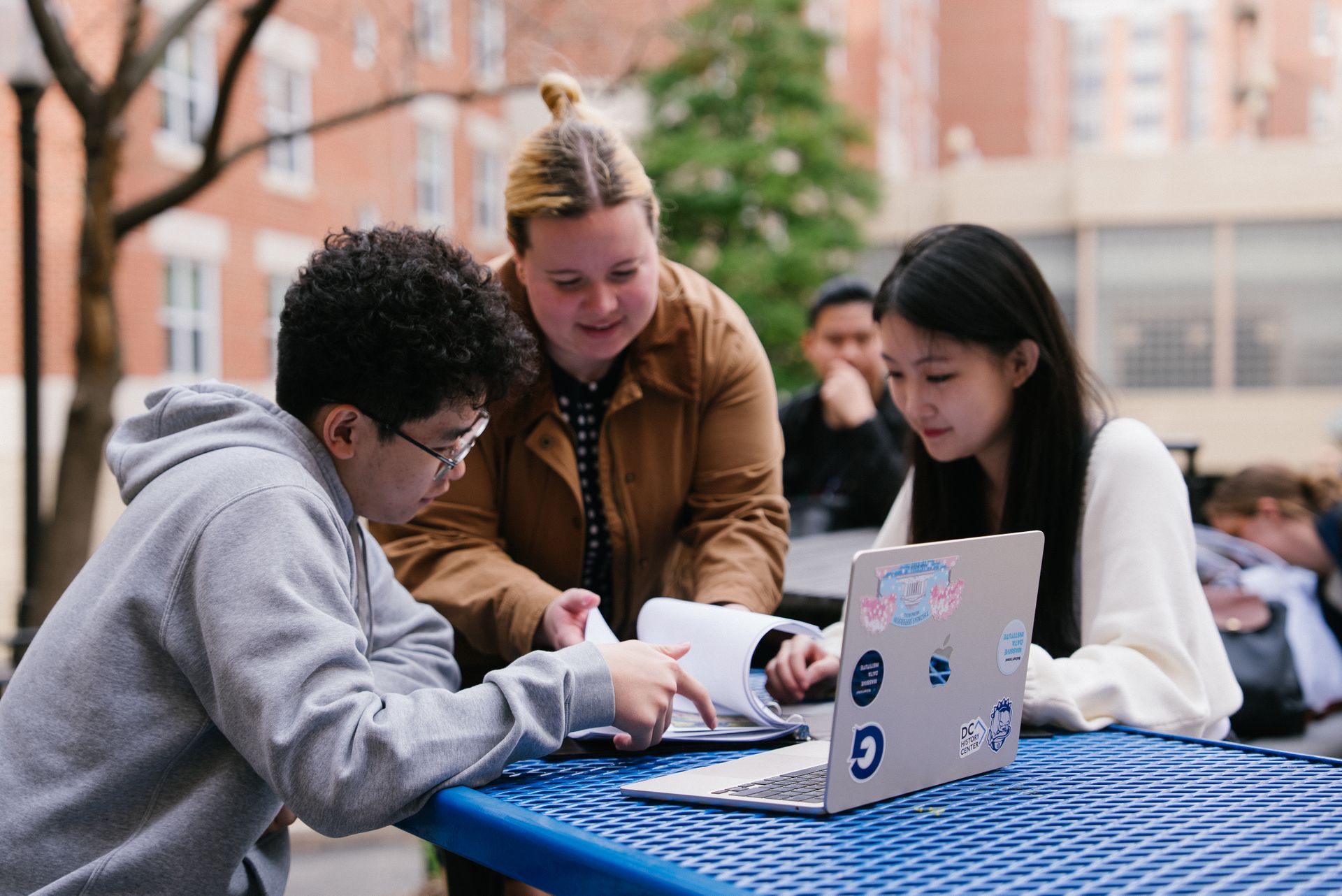 Three students studying together outside