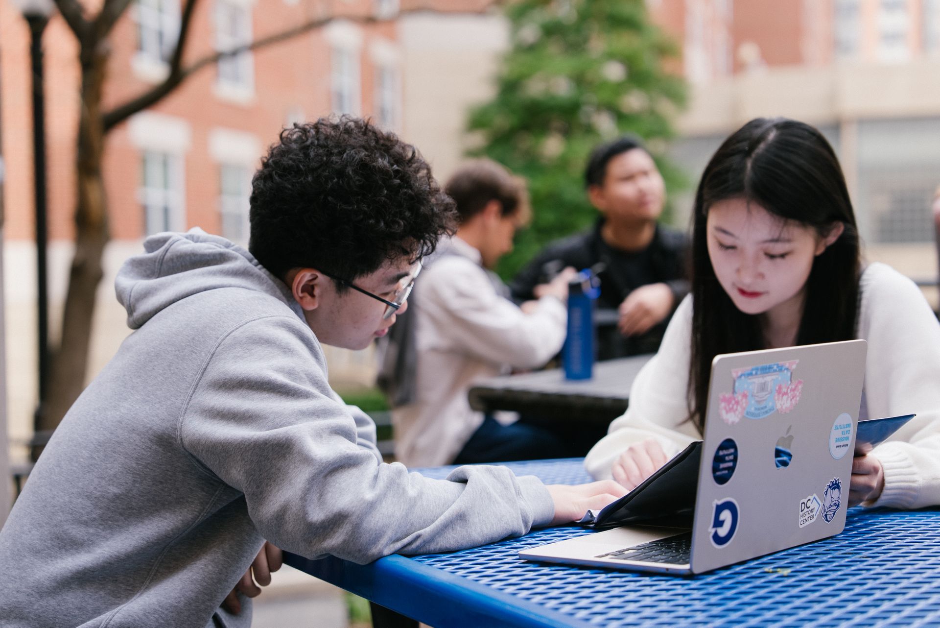 Students studying together outside.