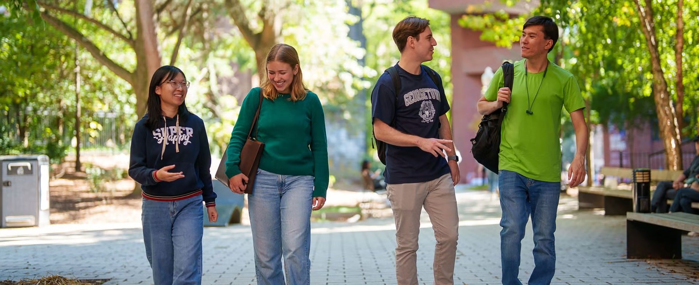 Four students walking and talking on campus