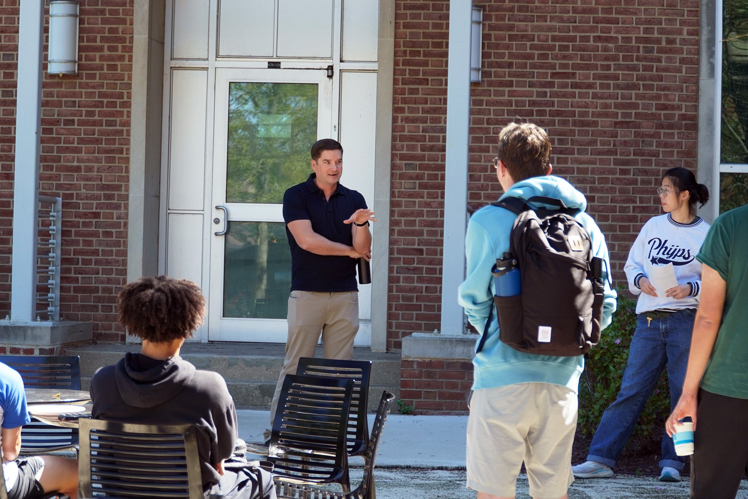 Student and prof outside a building talking